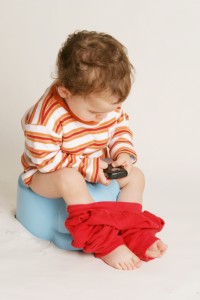 potty training boy on potty with phone