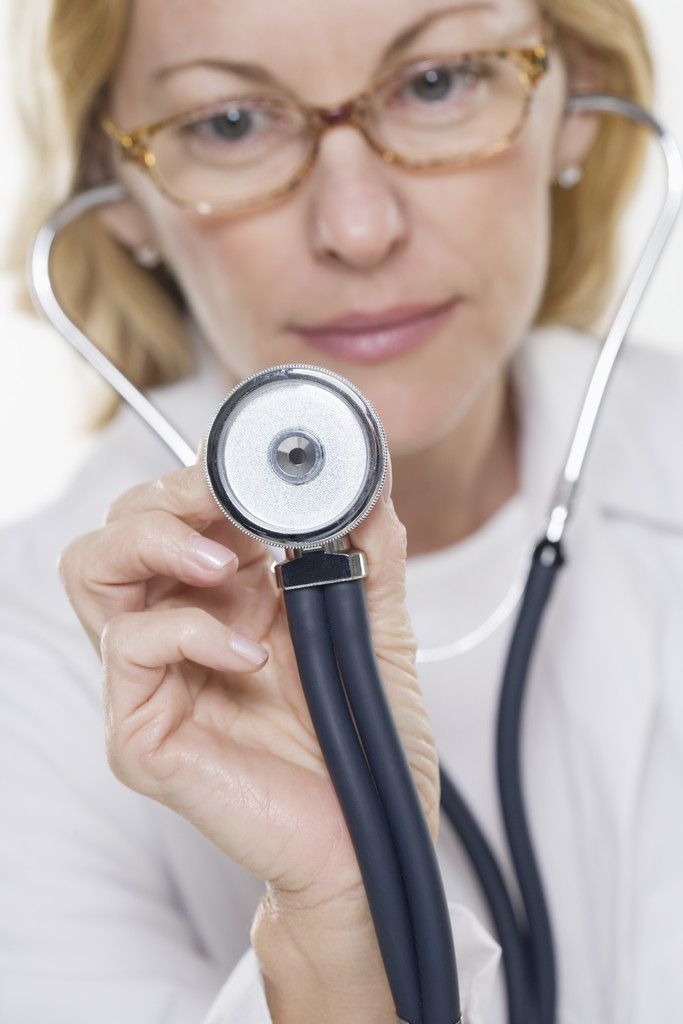 Physician Holding Out Stethoscope Woman doctor with stethoscope