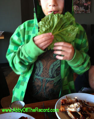 kid eating a huge lettuce leaf
