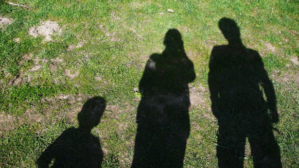 children's shadows on the grass